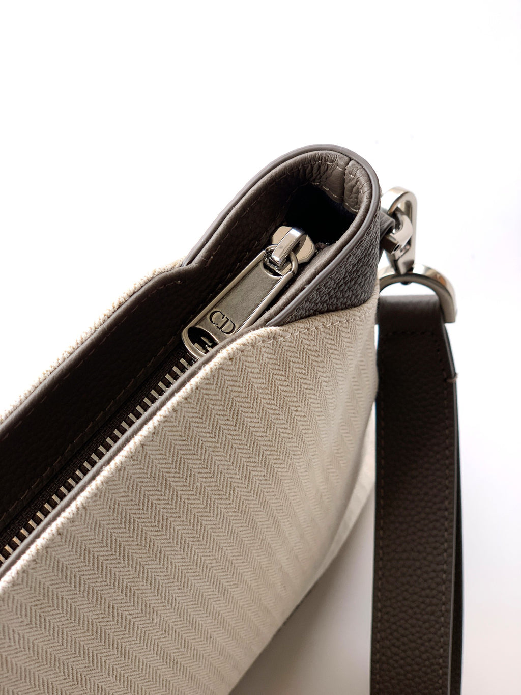 Dior men’s small zip pouch bag with zipper and light beige interior, shown side view