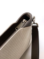 Dior bag zipper opening with herringbone lining and dark leather shoulder strap