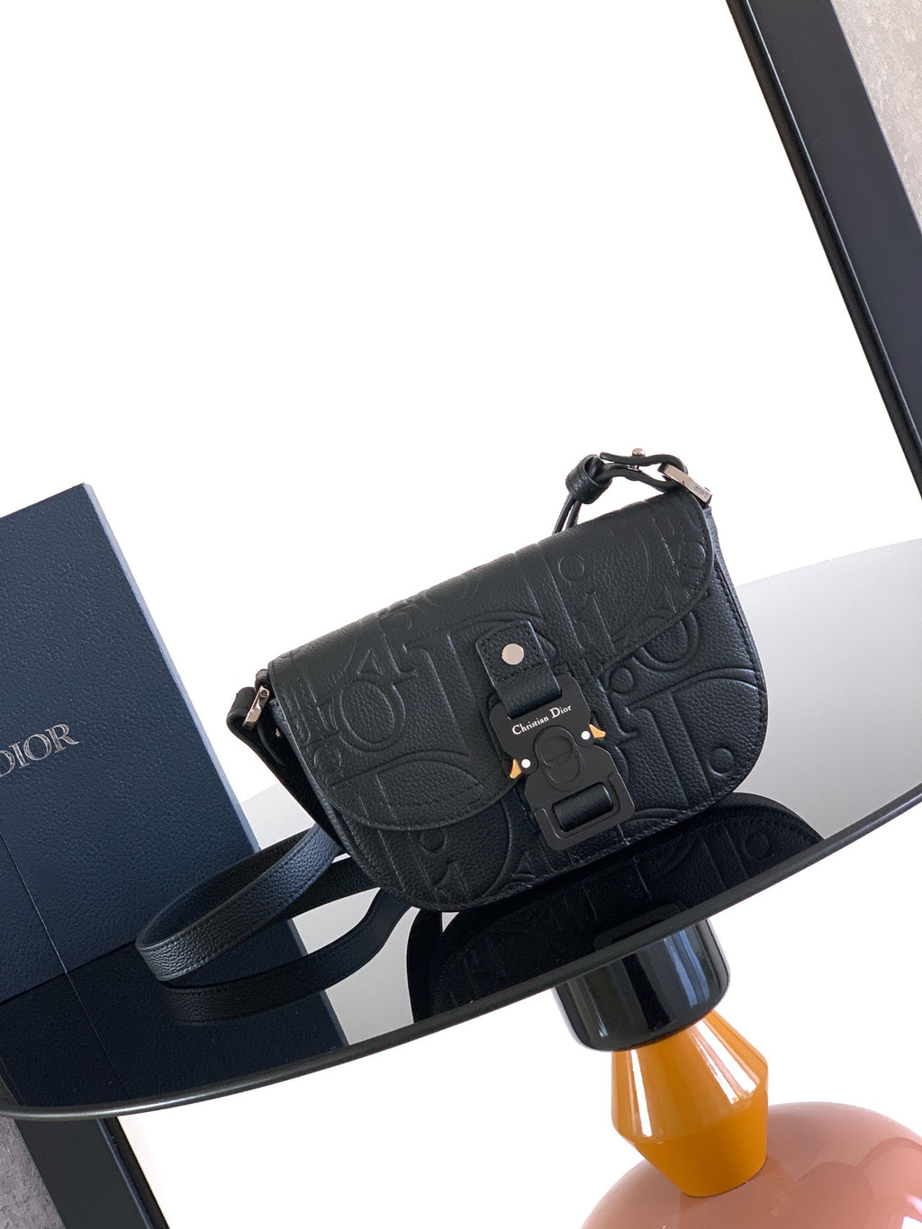 Dior small crossbody bag in dark leather, front flap with logo embossing and buckle