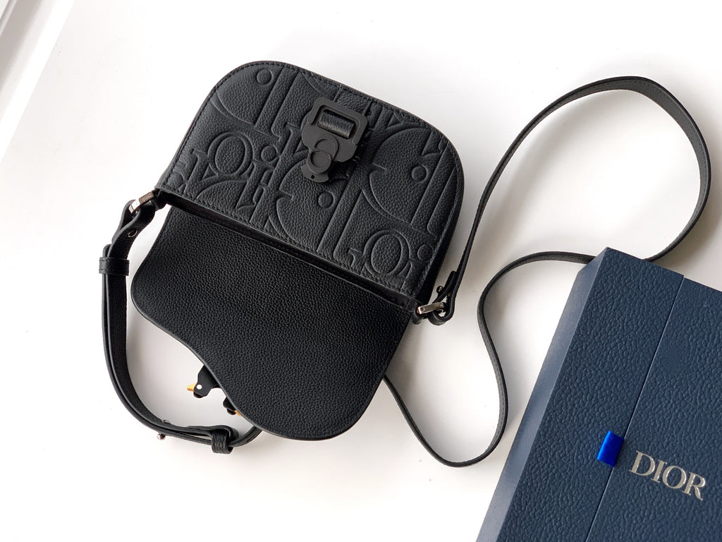 Black leather mini shoulder bag with embossed logo band, zipper pocket and strap