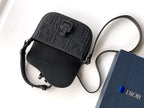 Black leather mini shoulder bag with embossed logo band, zipper pocket and strap