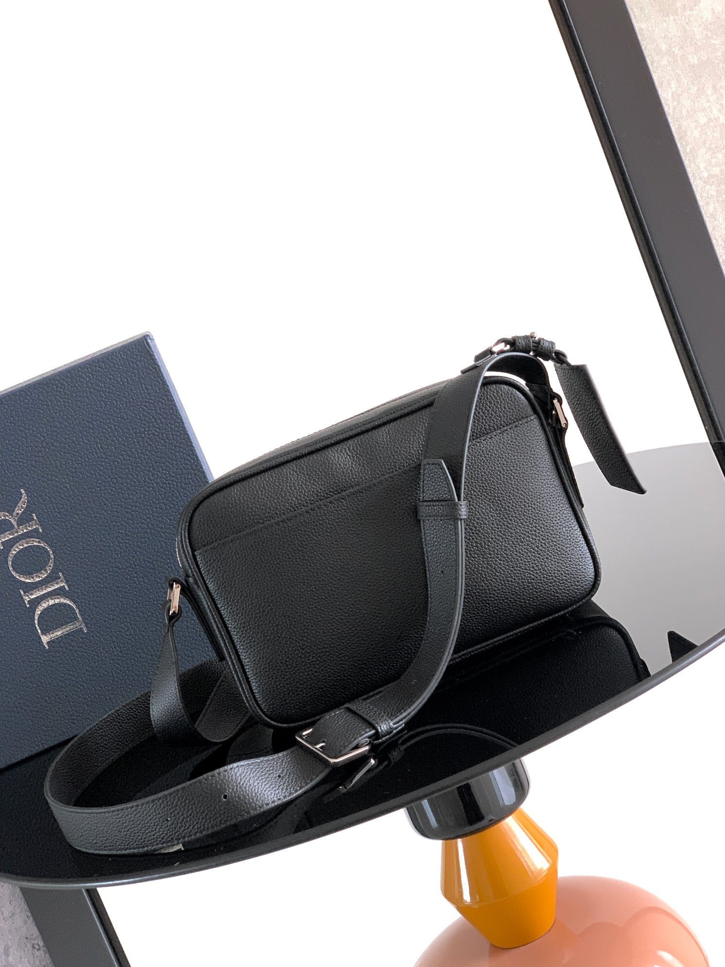 Dior leather shoulder bag with flap, side zipper, and long strap
