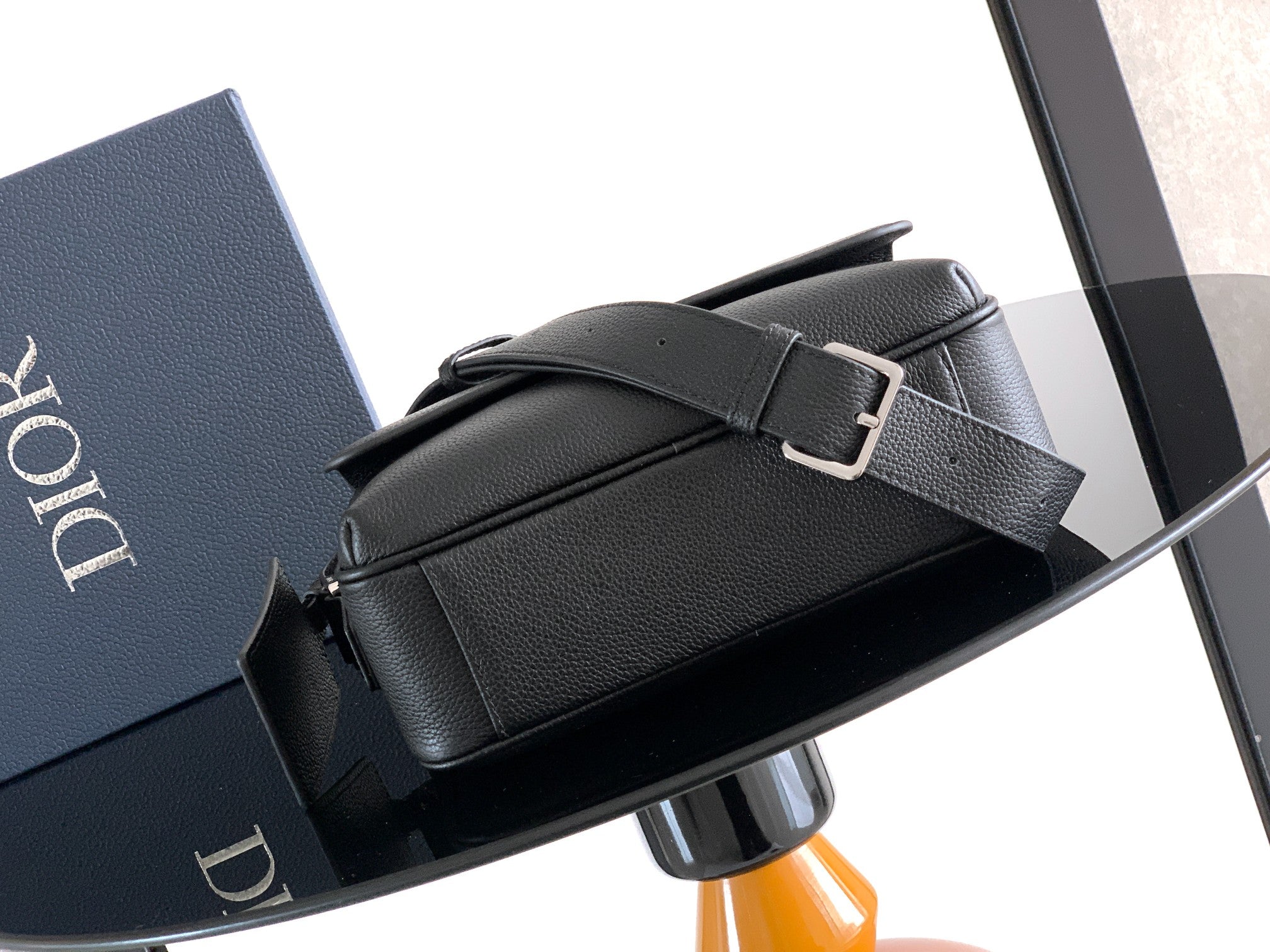 Men's Dior belt-style bag with front buckle strap and textured black leather