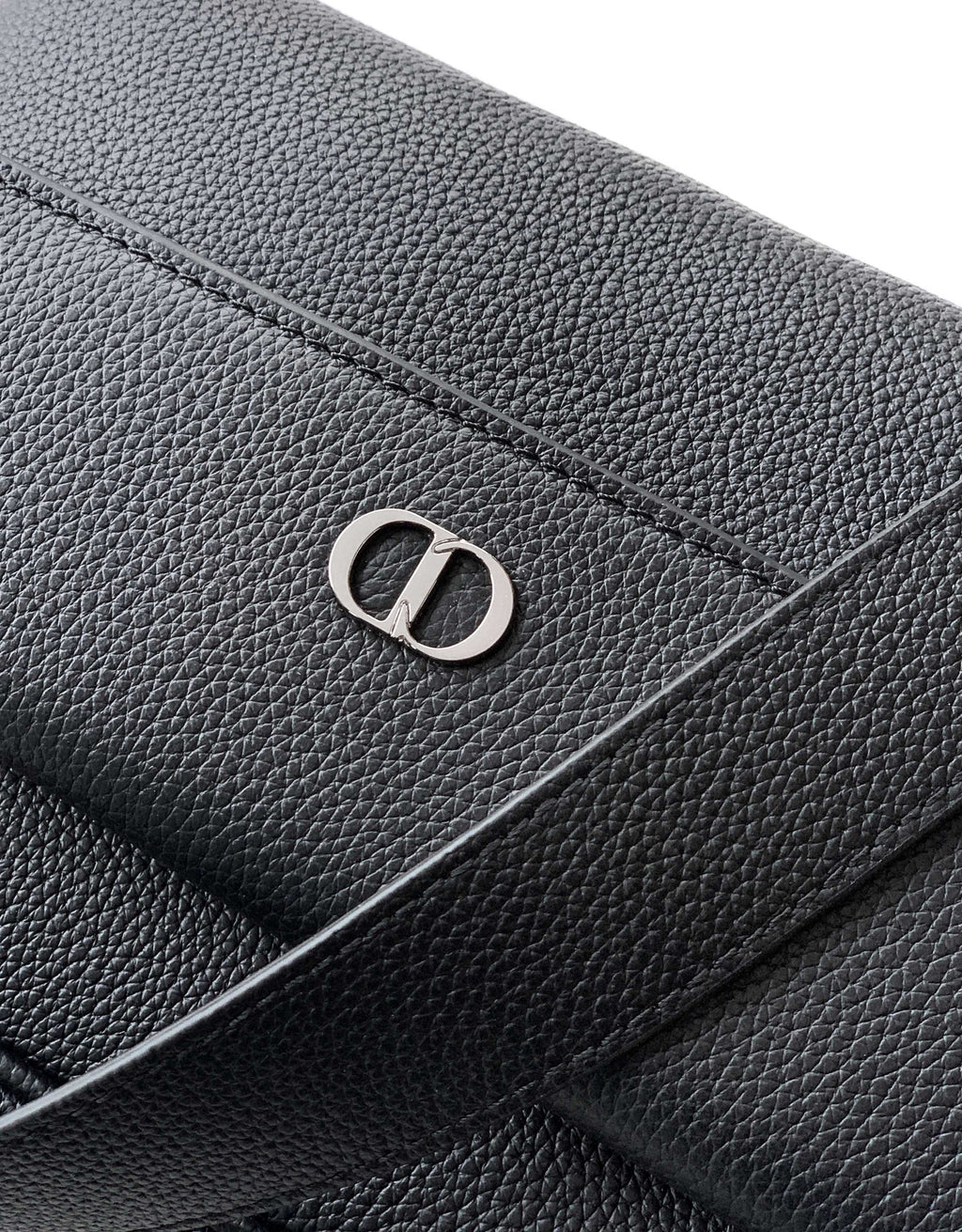 Dior leather flap with embossed D emblem and seam details