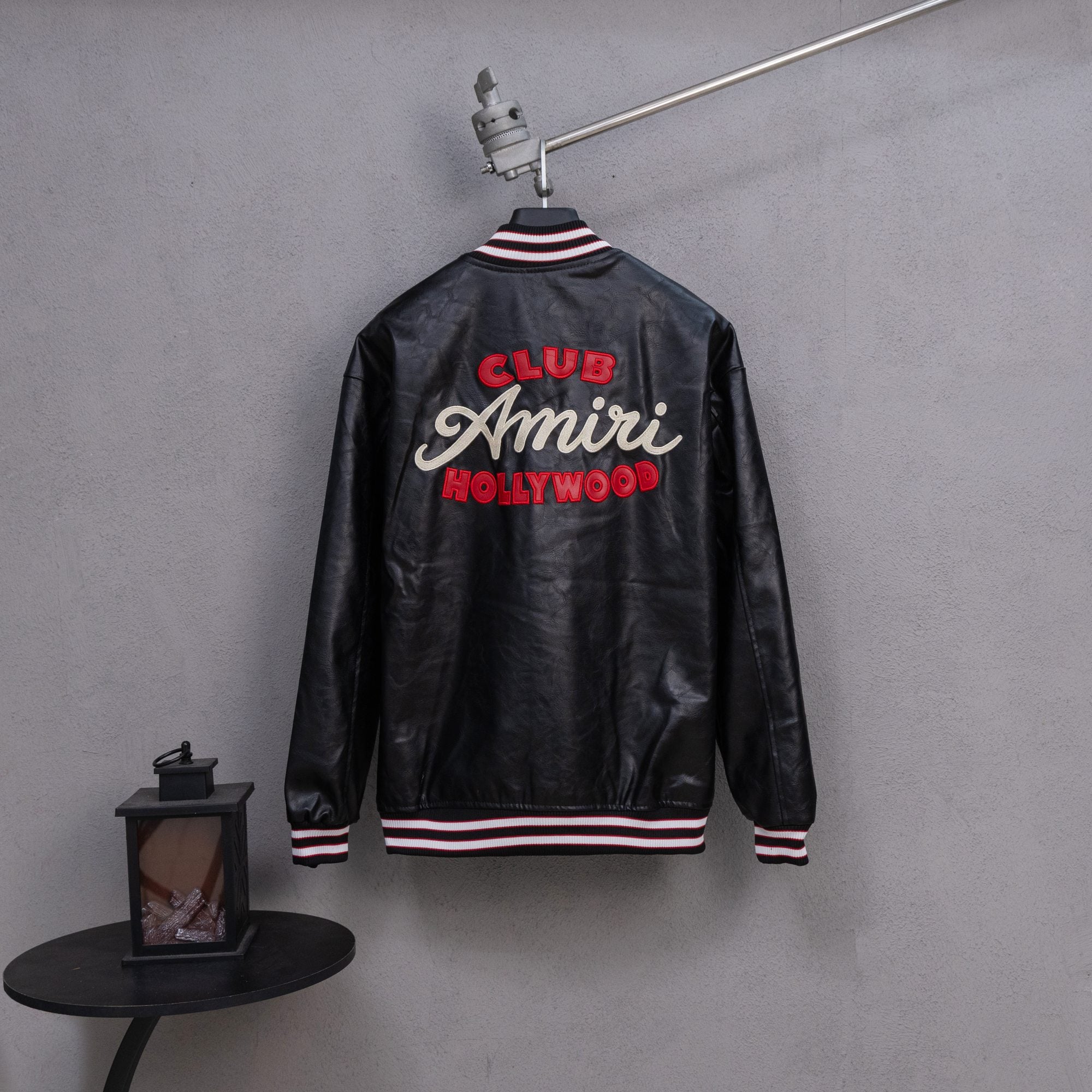 Amiri black leather bomber jacket back with “CLUB Amiri HOLLYWOOD” graphic