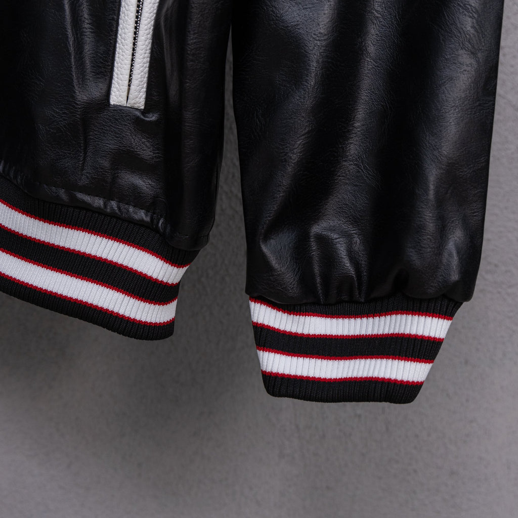 Amiri black leather bomber jacket cuffs with red, white, and black striped rib trim