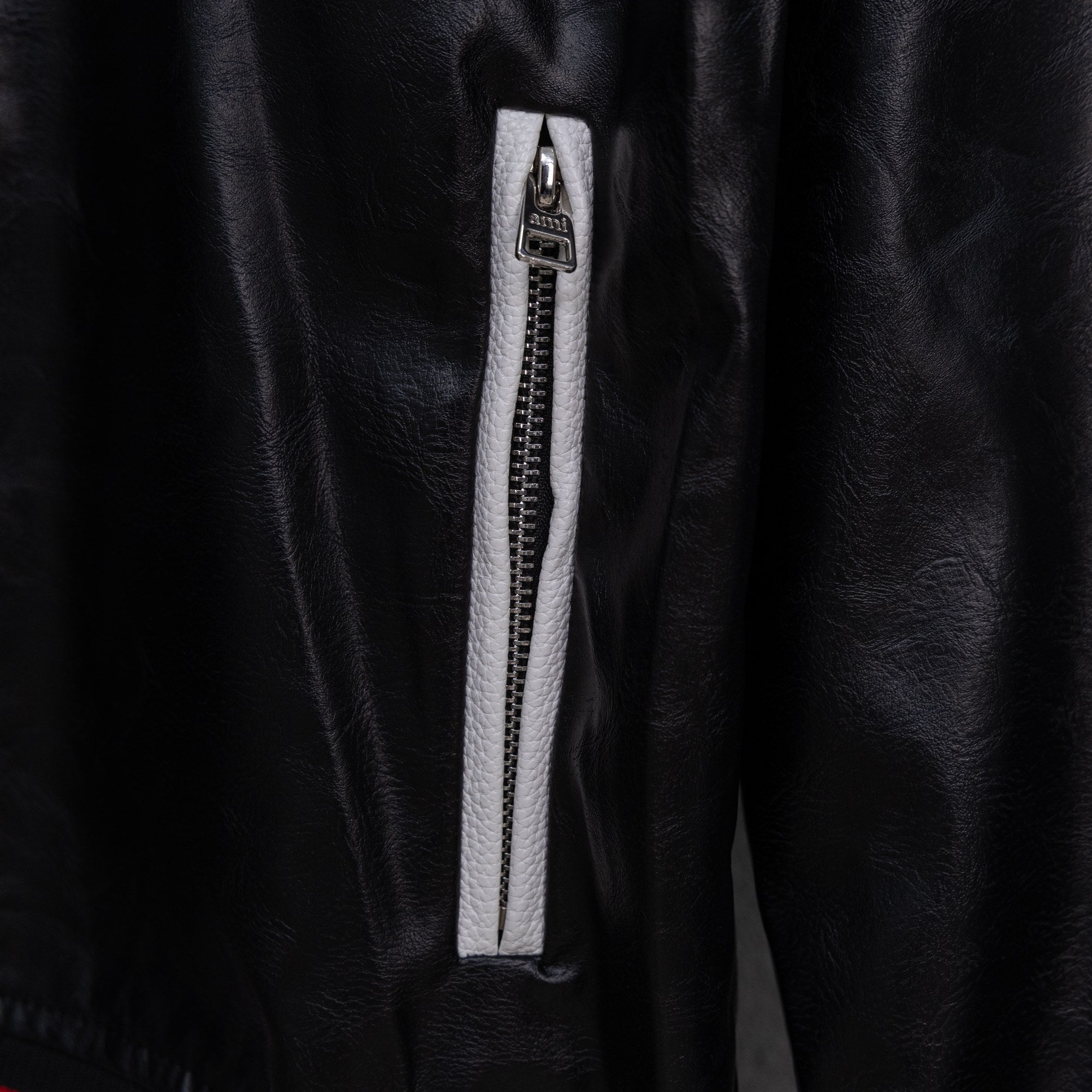 Amiri black leather jacket with zippered front pocket and silver zipper pull