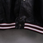Amiri black leather jacket front hem with red, white, and black striped ribbed trim