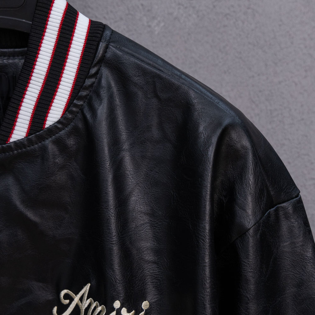 Amiri black leather bomber jacket with red-and-white striped collar trim and “Amiri” logo
