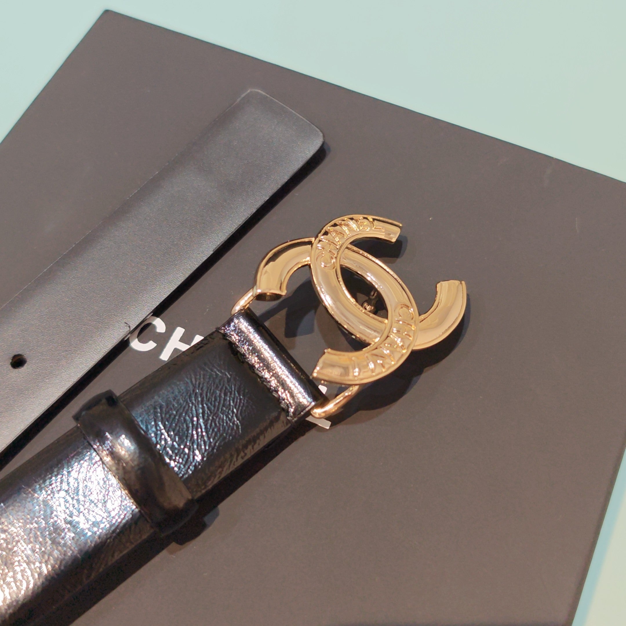 Chanel belt close-up: dark brown leather with rose-gold double C buckle and stones