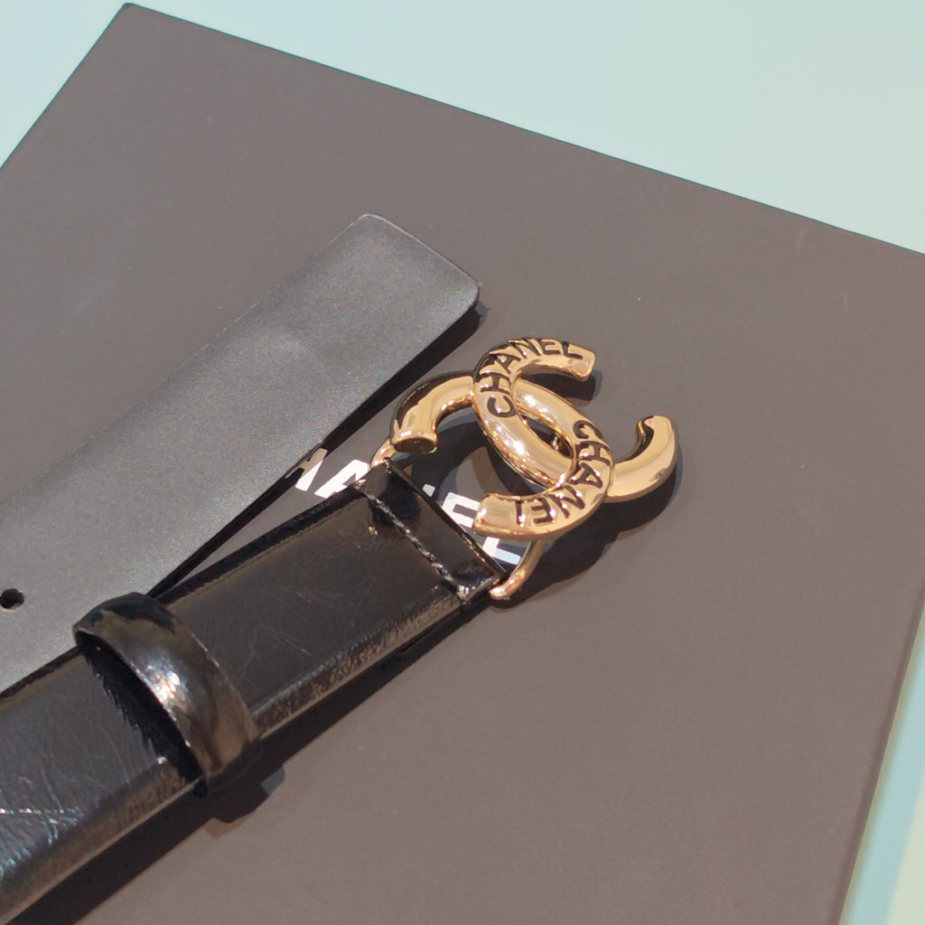 Chanel belt close-up: dark leather strap and gold-tone buckle with CC emblem