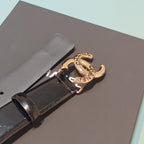 Chanel belt close-up: dark leather strap and gold-tone buckle with CC emblem