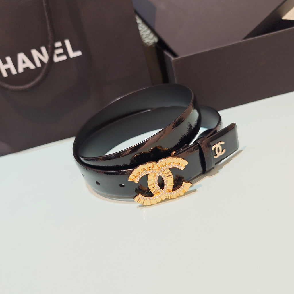 Chanel belt with dark leather strap, gold CC buckle plaque, and engraved clasp
