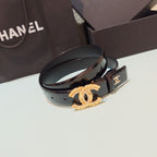 Chanel belt with dark leather strap, gold CC buckle plaque, and engraved clasp