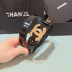 Chanel belt close-up: dark leather strap with oversized gold CC emblem with stones