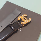 Chanel belt close-up of gold-tone CC buckle with rhinestones on dark leather
