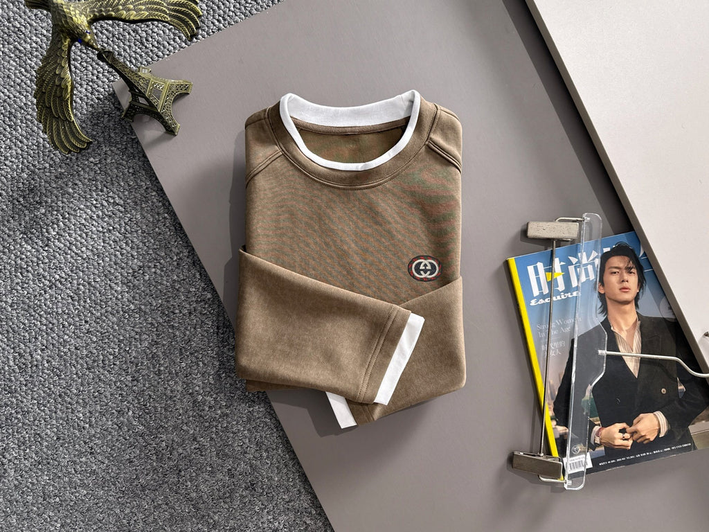 Gucci long-sleeve top with crew neck, white cuffs, and small chest logo