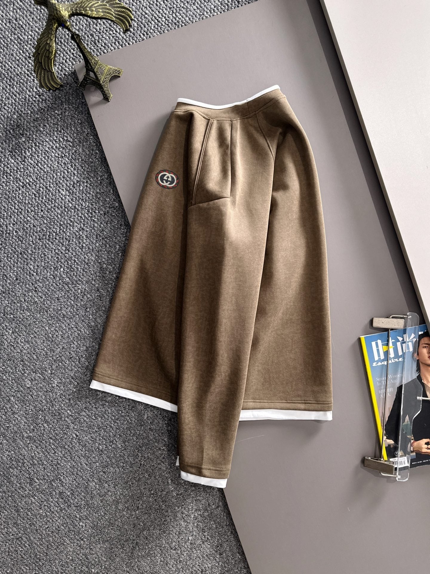 Gucci long-sleeve top with white hem and cuffs, featuring a small left chest logo