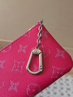 Hot pink Louis Vuitton small bag with chain strap and engraved metal clasp