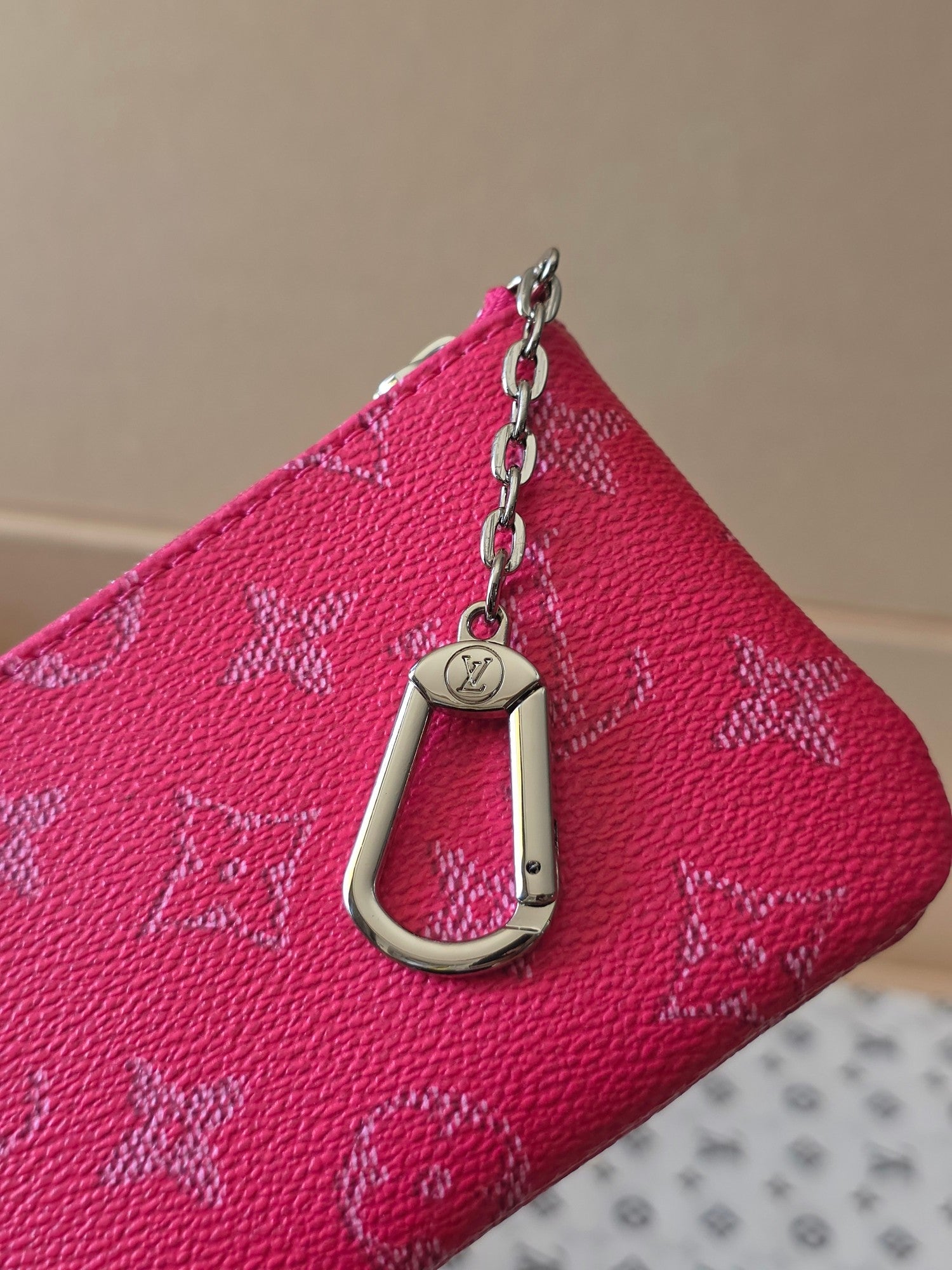 Louis Vuitton pink monogram bag corner with metal zipper pull and chain key fob