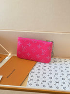 Hot pink Louis Vuitton small zip pouch bag with monogram pattern, side view