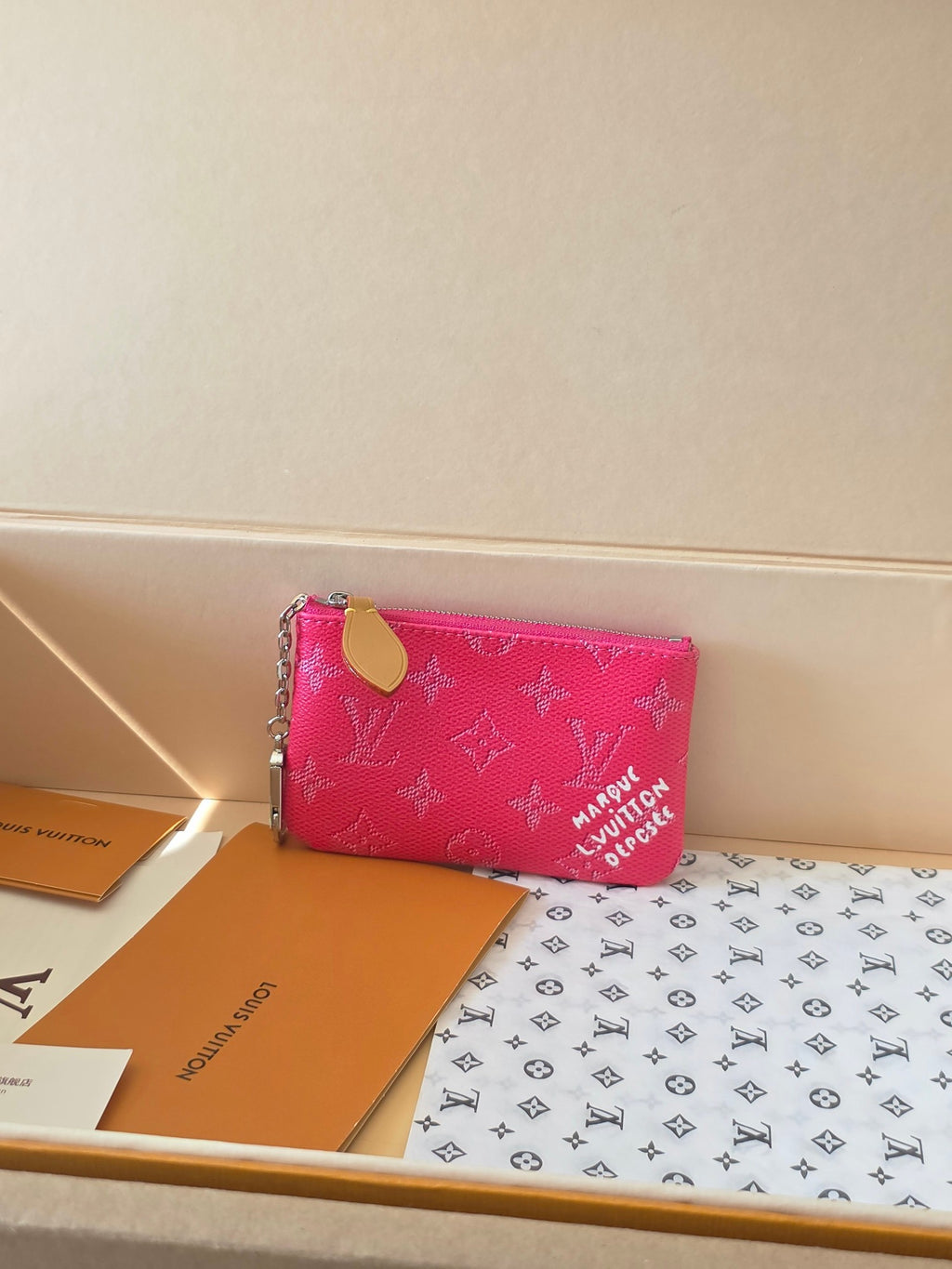 Hot pink Louis Vuitton small crossbody bag with monogram pattern and zip closure