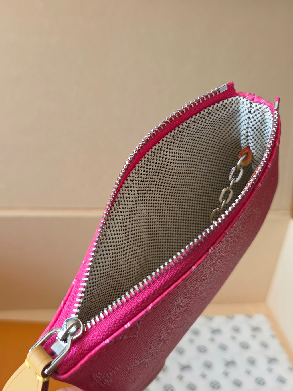 Louis Vuitton pink monogram mini bag showing interior mesh lining and zipper edge