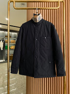 Burberry black quilted jacket with button front and stand collar, long sleeves