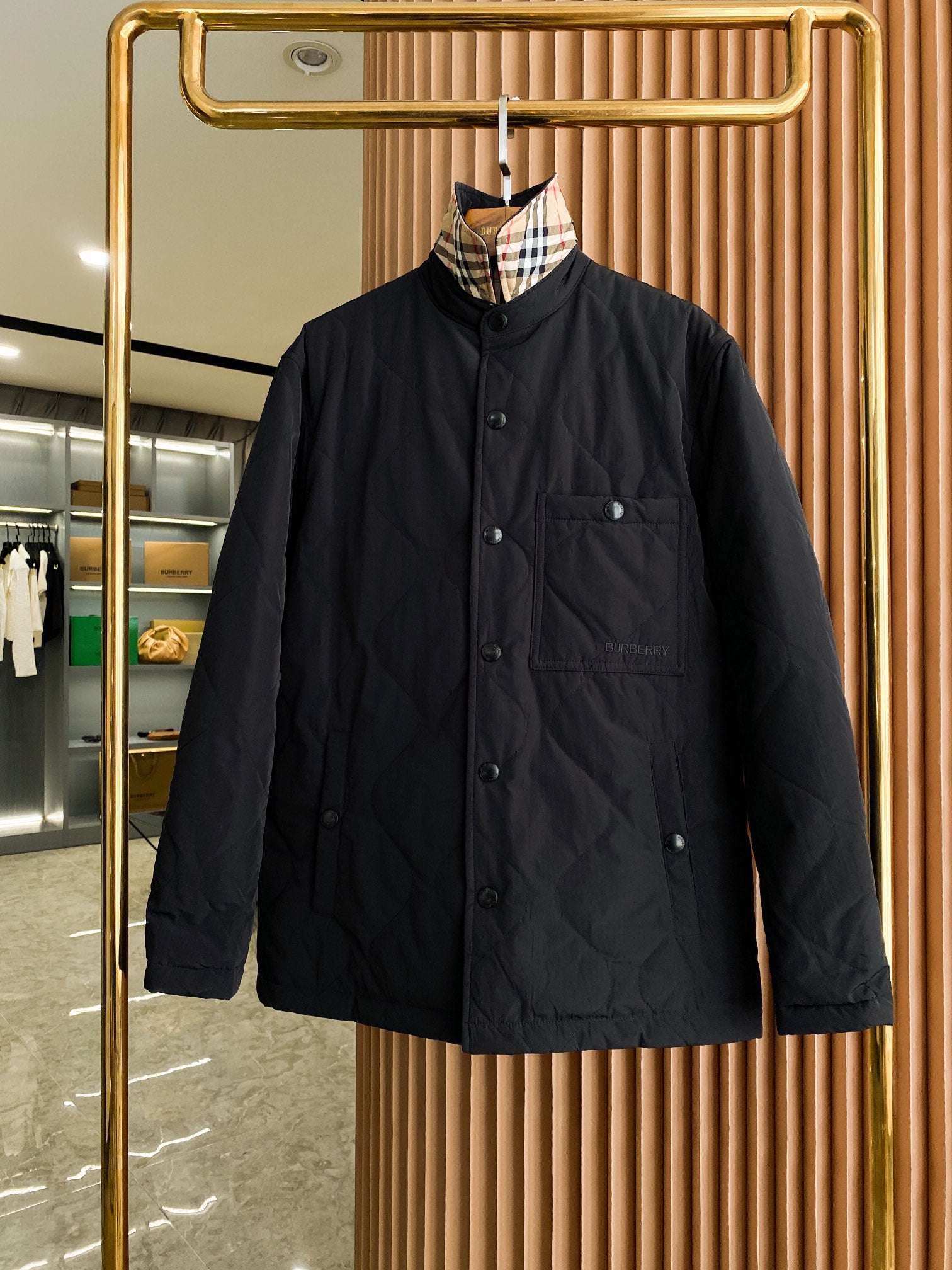 Burberry black quilted jacket with button front and stand collar, long sleeves