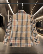 Long plaid quilted jacket back view with shoulder yoke and two-part collar.