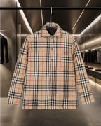 Long plaid quilted jacket with button-up front, pointed collar, and dark interior hood.