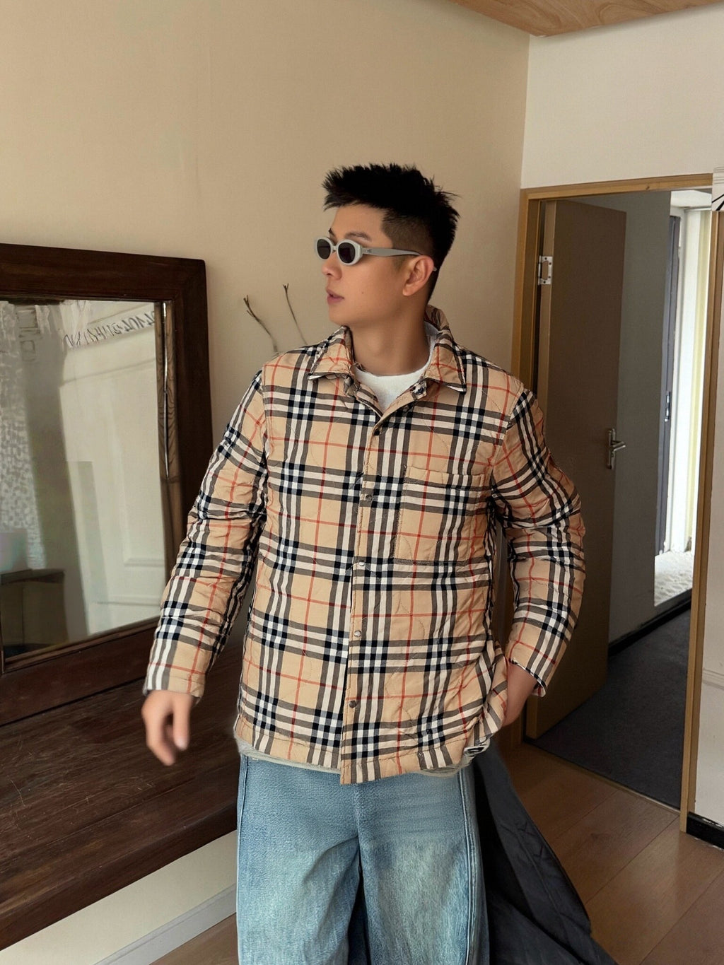 Plaid button-up jacket in beige, navy, and red with black trim