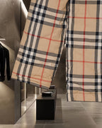 Burberry plaid jacket side view with long sleeves and buttoned front, beige black red check