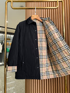 Black long jacket on hanger with plaid lining and button front