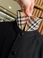 Plaid-lined inner collar of black jacket with button placket