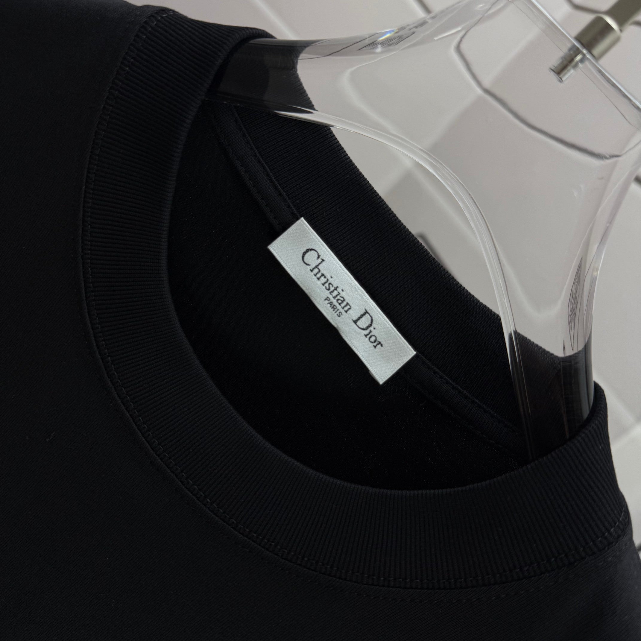 Black short-sleeve shirt neckline with Dior label at collar