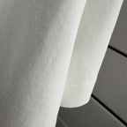 Dior white short-sleeve T-shirt fabric close-up with subtle texture