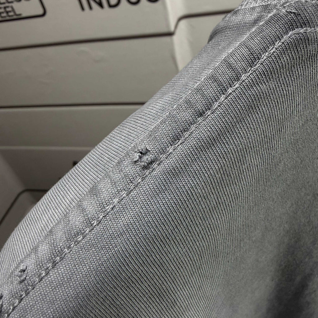 Light gray short-sleeve T-shirt collar stitching detail with reinforced seams.