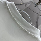 Off-white T-shirt neckline edge close-up with stitched collar