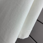 White T-shirt side view showing fabric and hem seam