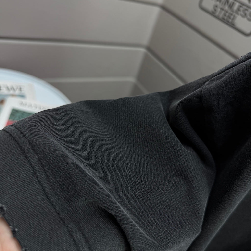 Black T-shirt shoulder and sleeve edge close-up