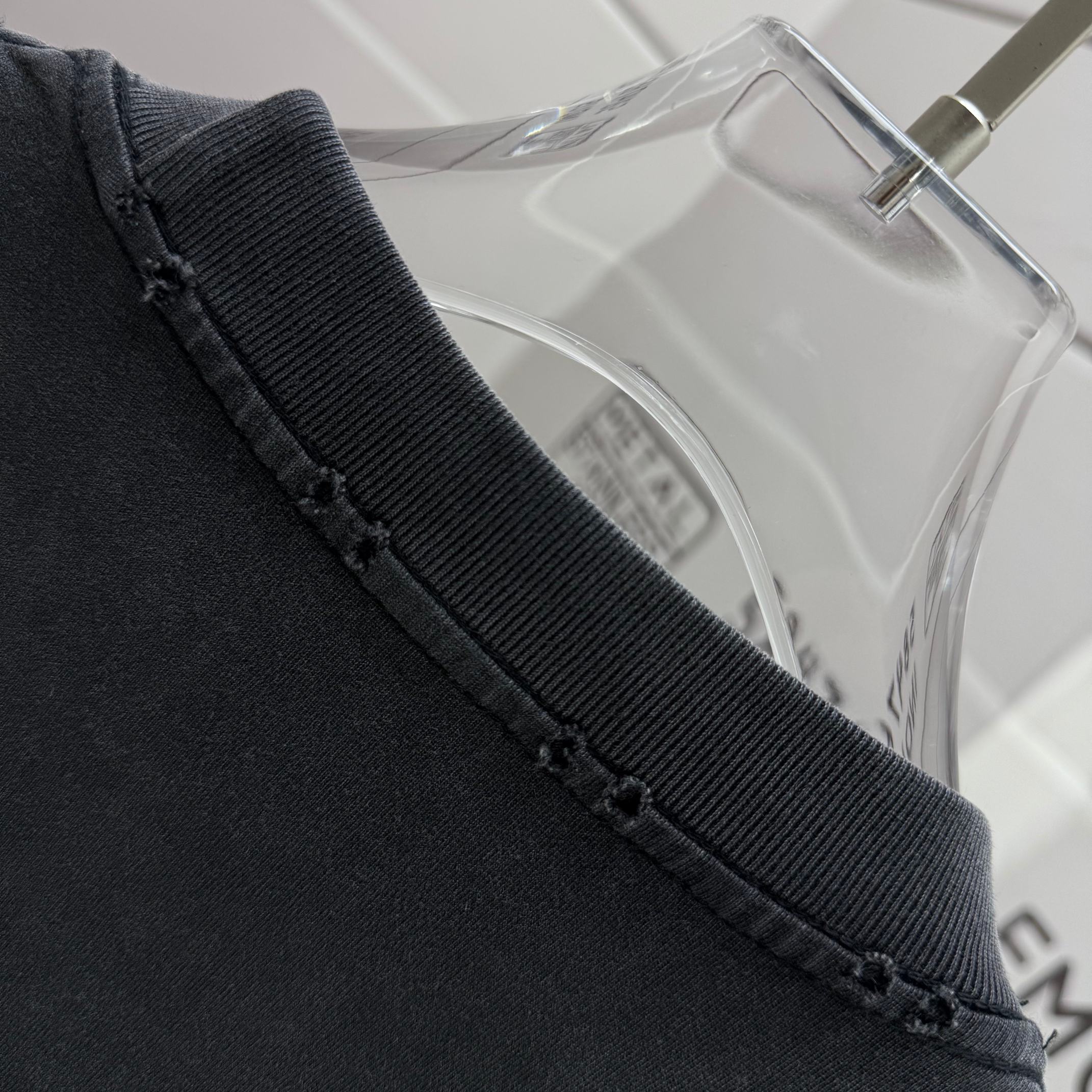 Black T-shirt ribbed collar and stitched neckline edge detail