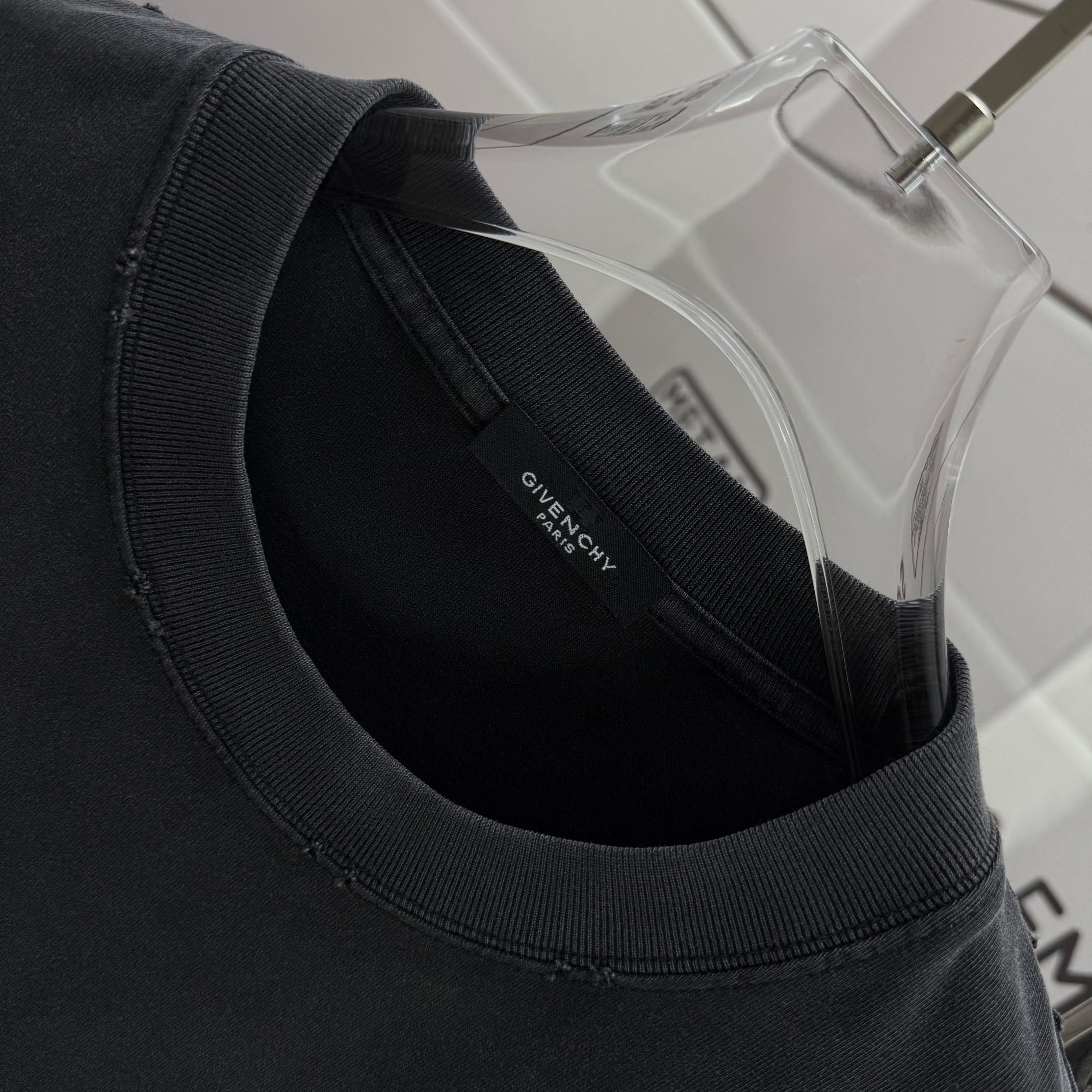 Black T-shirt crew neck with small GIVENCHY label inside collar.
