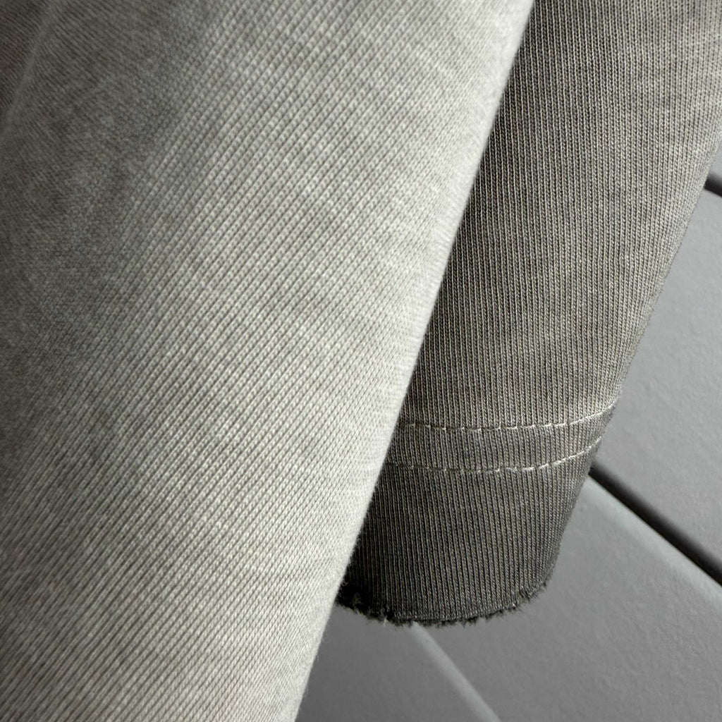 Gray T-shirt sleeve seam and ribbed hem detail