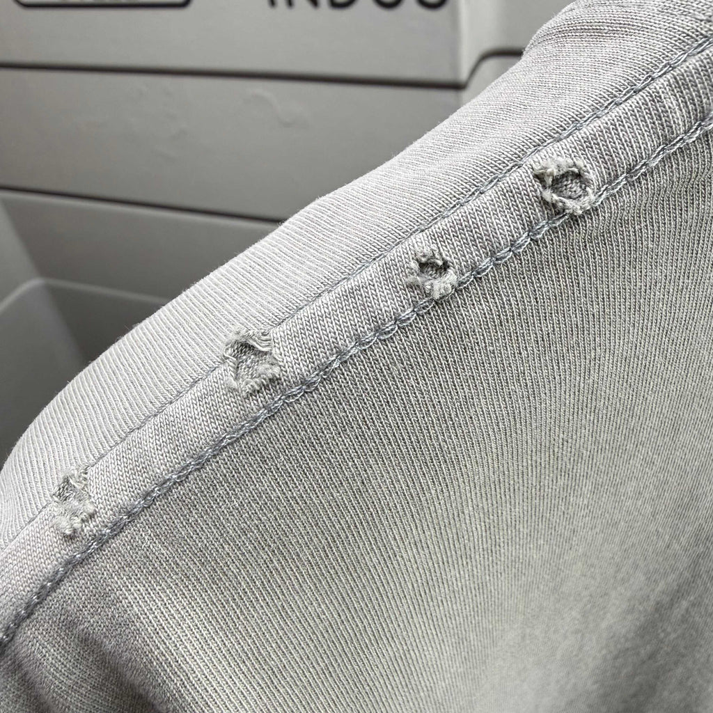 Gray T-shirt shoulder seam with stitched overlock detail
