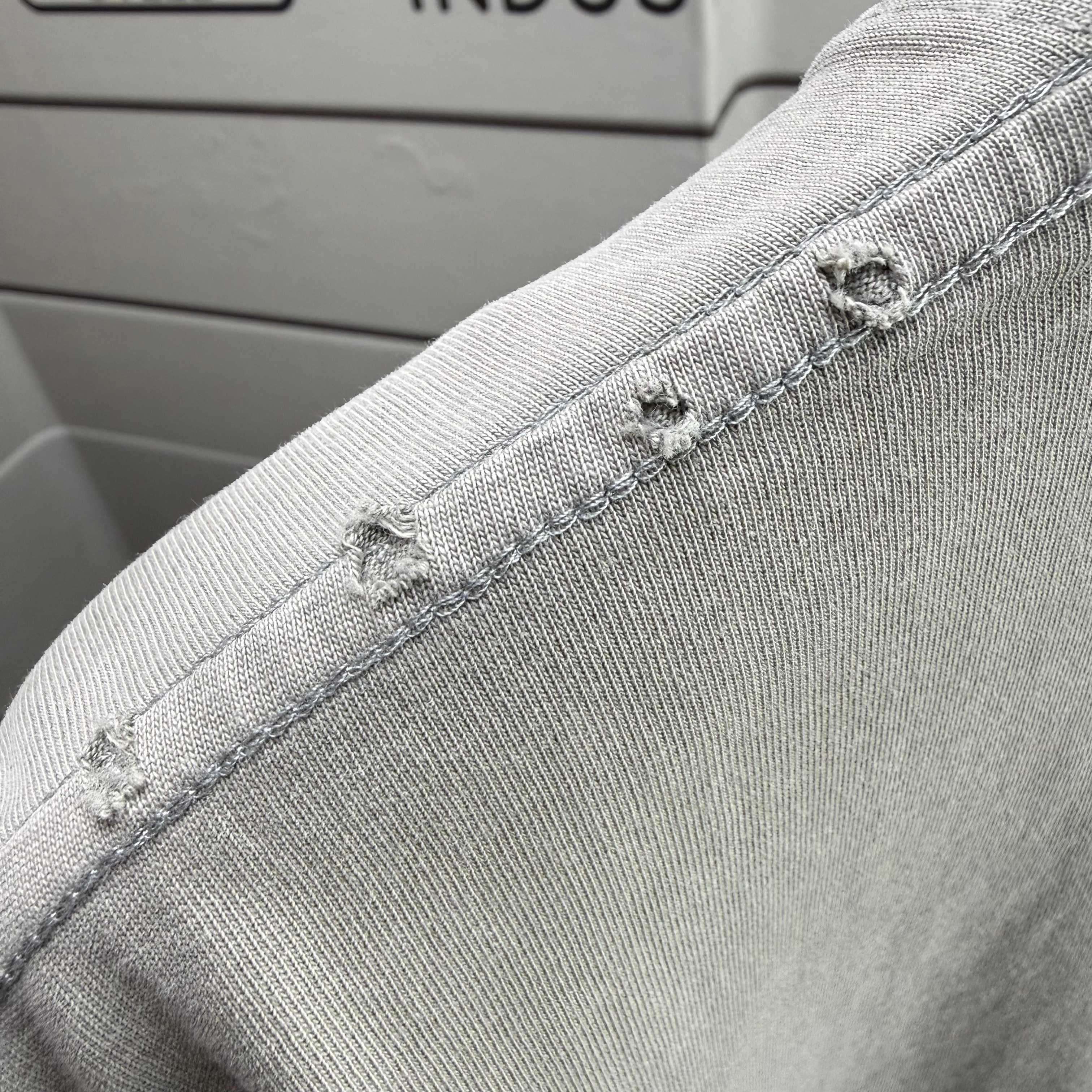 Off-White T-shirt hem with visible stitching along the cuff