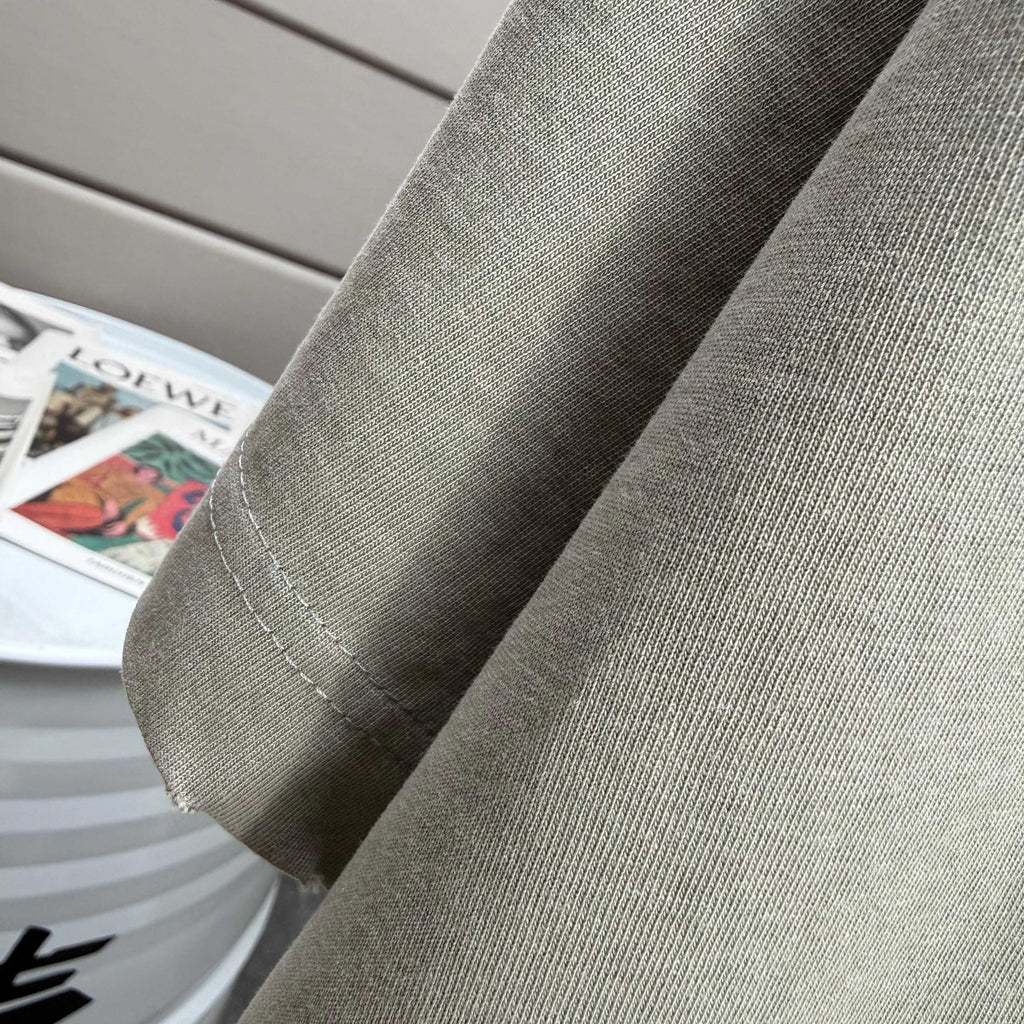 Light gray T-shirt sleeve and side seam detail