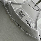 Off-White T-shirt hem edge with tag showing Metal Glasses logo