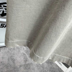 Light gray T-shirt bottom hem with attached size label