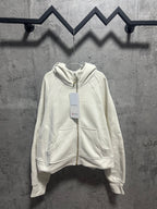 Off-white zip-up hoodie with drawstring hood and kangaroo pocket
